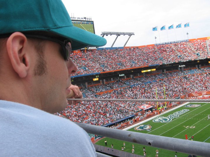 Man sits at football game